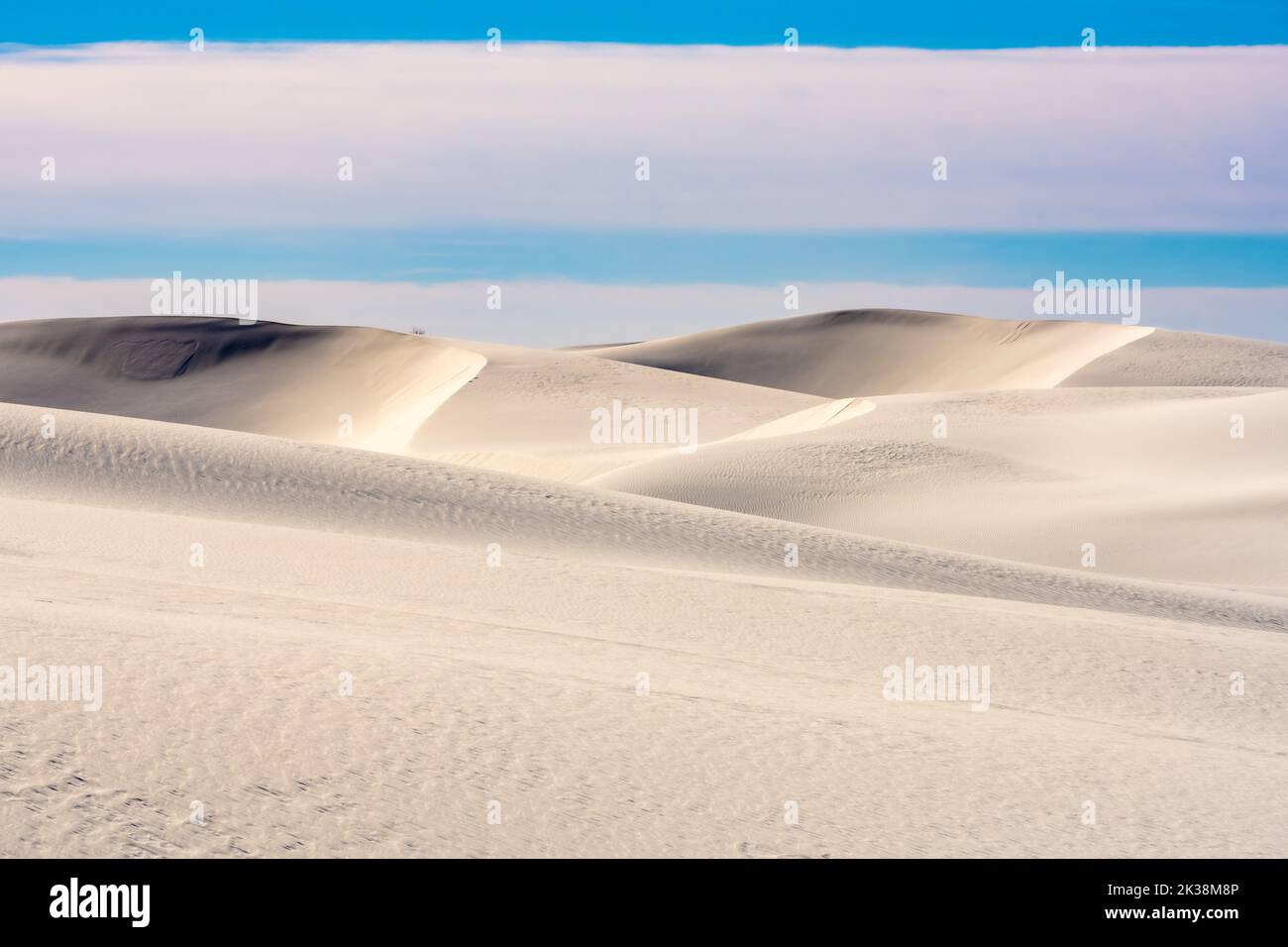 Smooth Untouched Dunes Under A Cloudy Sky in White Sands National Park Stock Photo