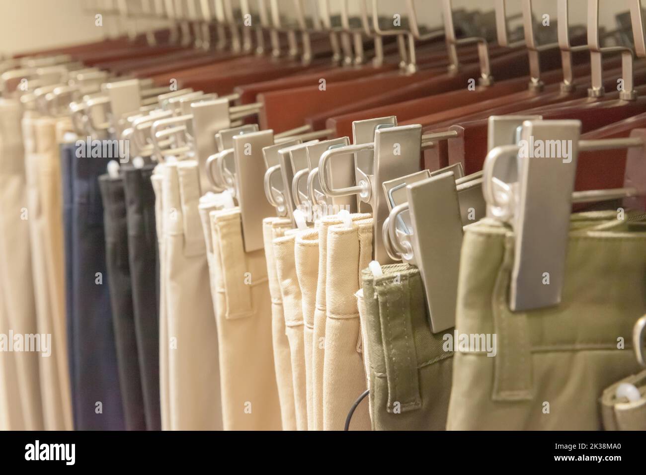 Group of sage pants on hanger at retail shop Stock Photo Alamy