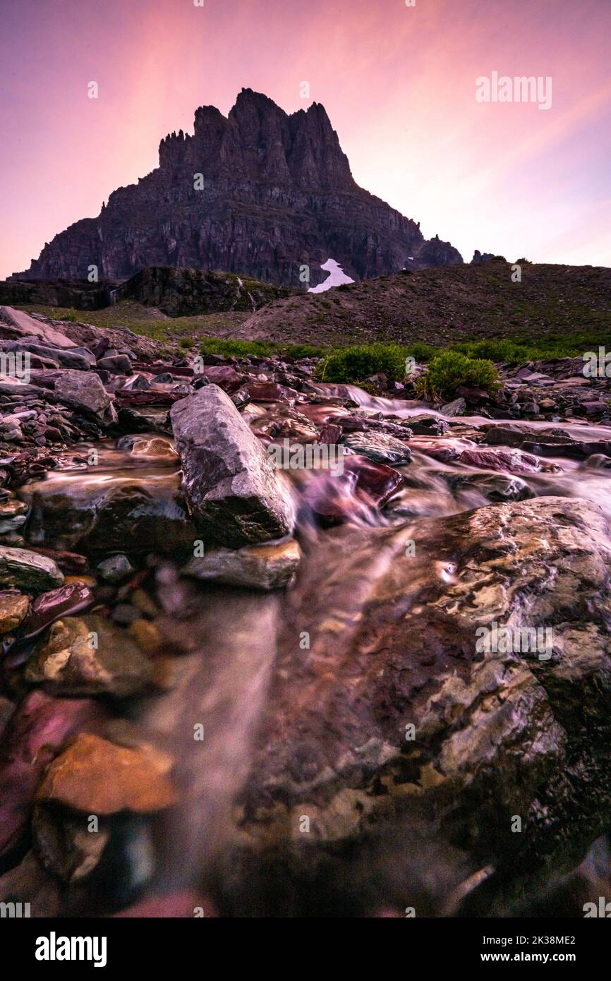 Snowmelt Runs Down The Side of Clements Mountain At Sunset in Glacier National Park Stock Photo