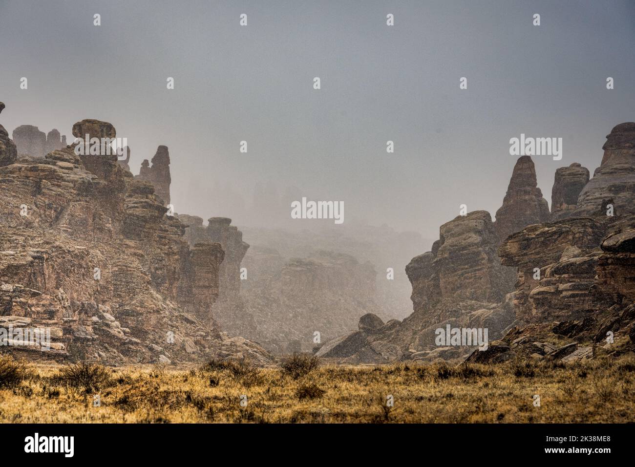 Snow Falls Over The Rock Formations At The Beginning Of Cyclone Canyon in Canyonlands National Park Stock Photo