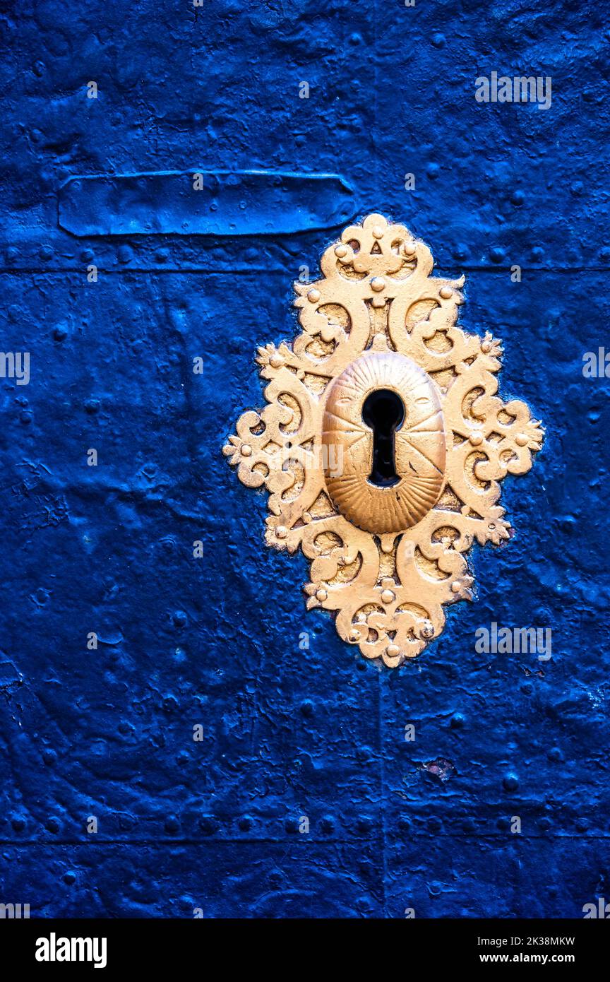 Antique golden key hole in the medieval entrance door. Stock Photo