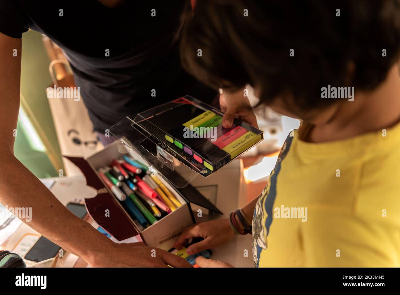 family prepares back to school supplies in home. Cangas, Spain, September 6 - 2022 Stock Photo