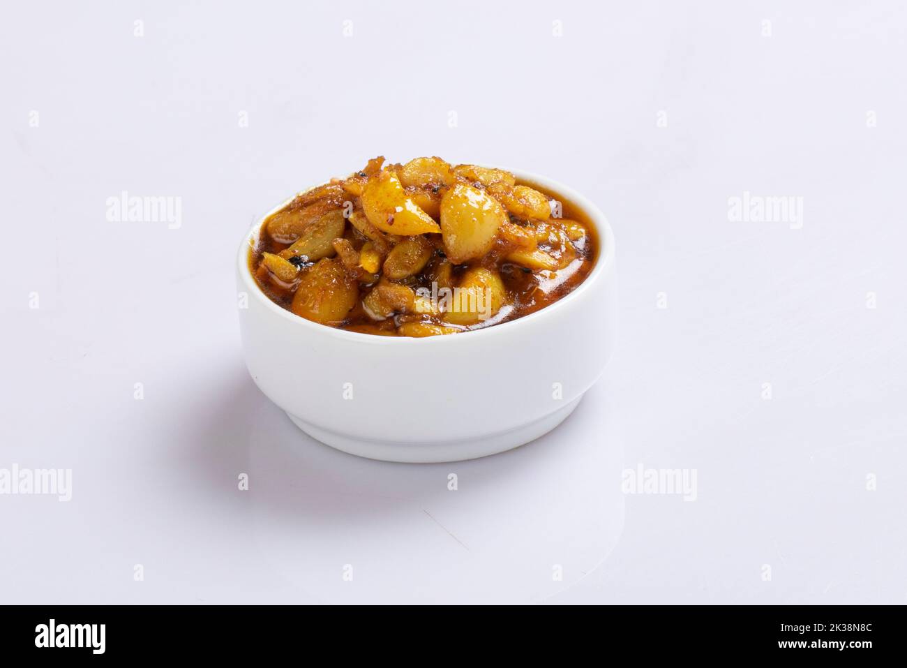 Fermented garlic cloves in a jar of honey, a rich source of probiotics, over a rustic wood background table. Selective focus with blurred background. Stock Photo