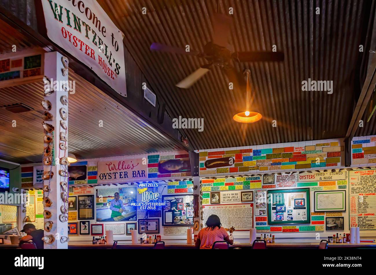 A tourist sits at the oyster bar in Wintzell’s Oyster House on Dauphin Street, Sept. 24, 2022, in Mobile, Alabama. Wintzell’s was established in 1938. Stock Photo