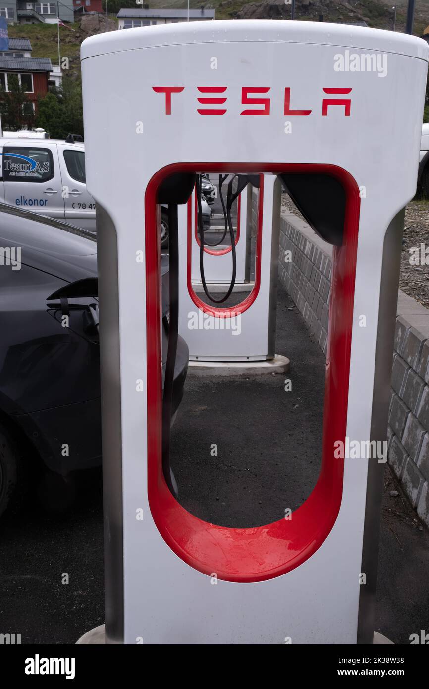Honningsvag, Norway - July 26, 2022: A static shot of a solid black Tesla Model 3 dual motor charging at the Honningsvag Supercharger in a cloudy summ Stock Photo