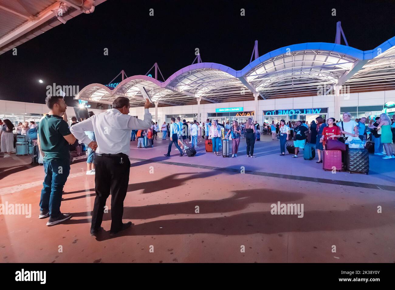 17 July 2022, Antalya, Turkey: arrival international terminal of Airport with crowds of tourists at night. Huge tourist traffic concept Stock Photo