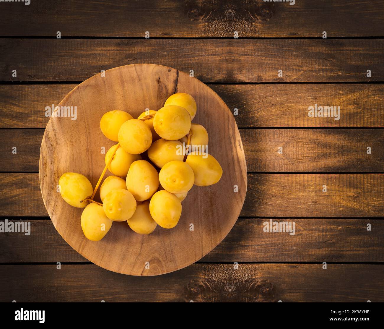 Organic green dates in the wooden bowl Phoenix dactylifera Stock
