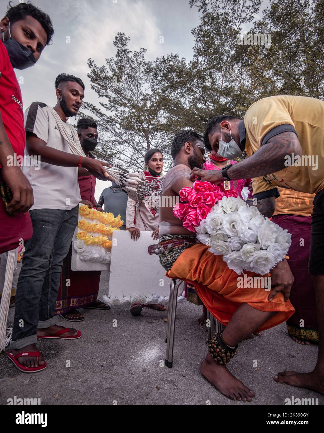 A Hindu devotee seen with sharp self piercing on body as ceremonial act during Thaipusam festival Stock Photo