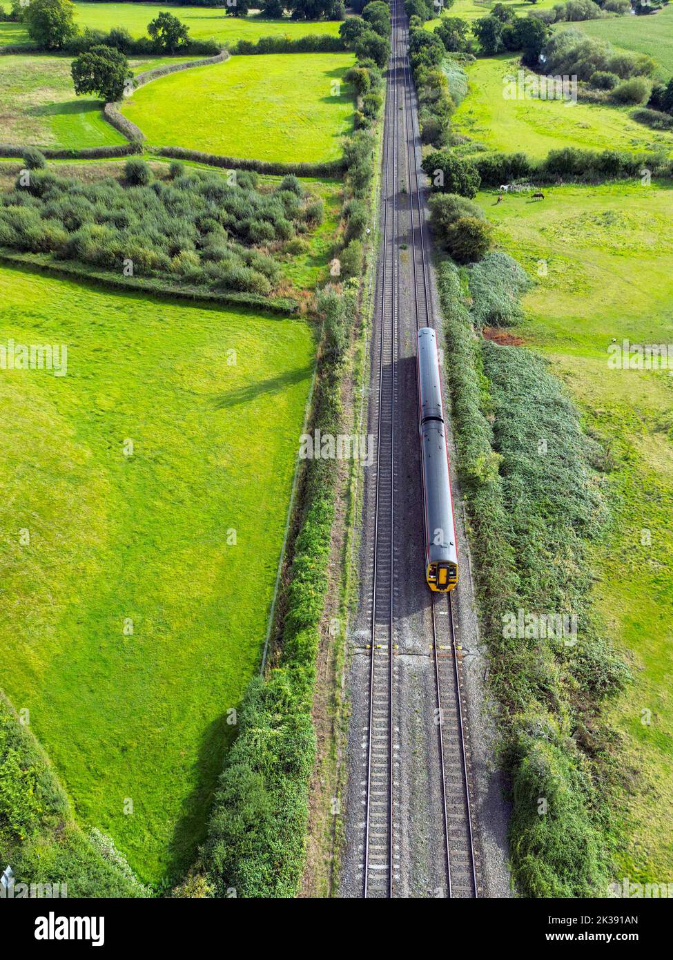 Bonvilston, Vale of Glamorgan, Wales - September 2022: Aerial view of a commuter train on a main railway line through countryside near Cardiff Stock Photo