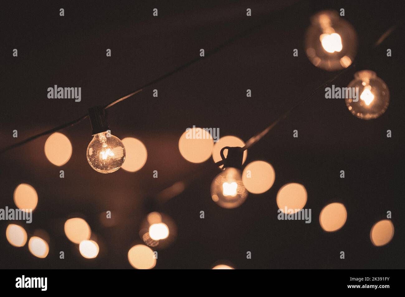 Nighttime view of string lights at an outdoor cafe Stock Photo Alamy