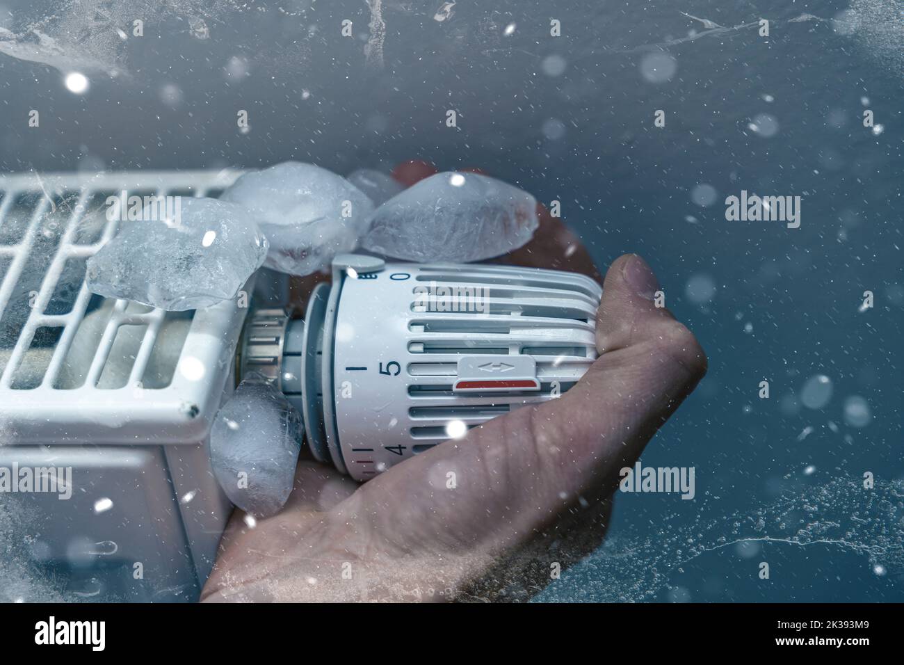 25 September 2022: Hand Turns Geforen Radiator To 0, Symbol Image Cold Heating, Freeze In Winter PHOTOMONTAGE Stock Photo