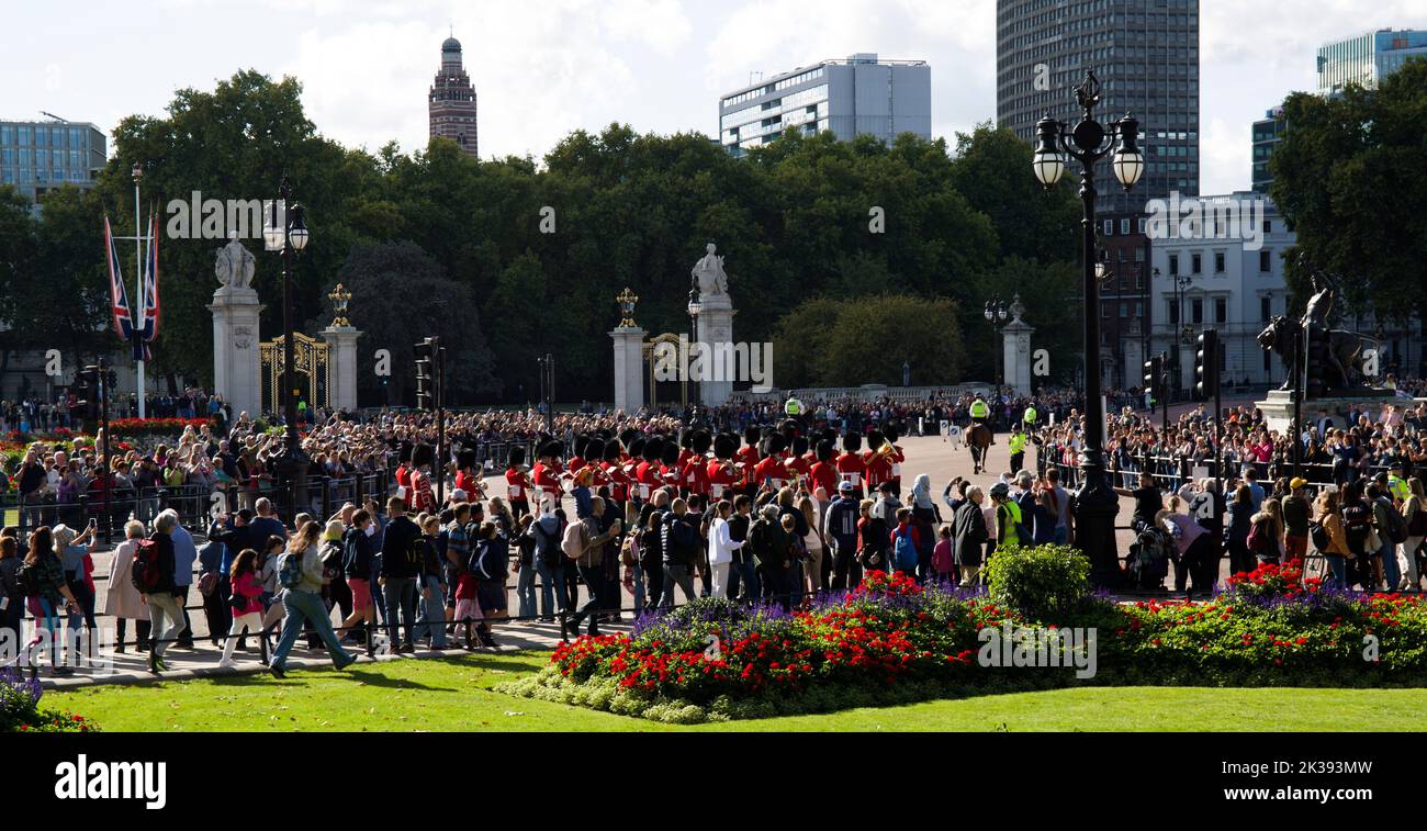 Crowds of Sightseers and Tourists Watching Marching Guards Band Queen Victoria Monument and Buckingham Palace London Stock Photo