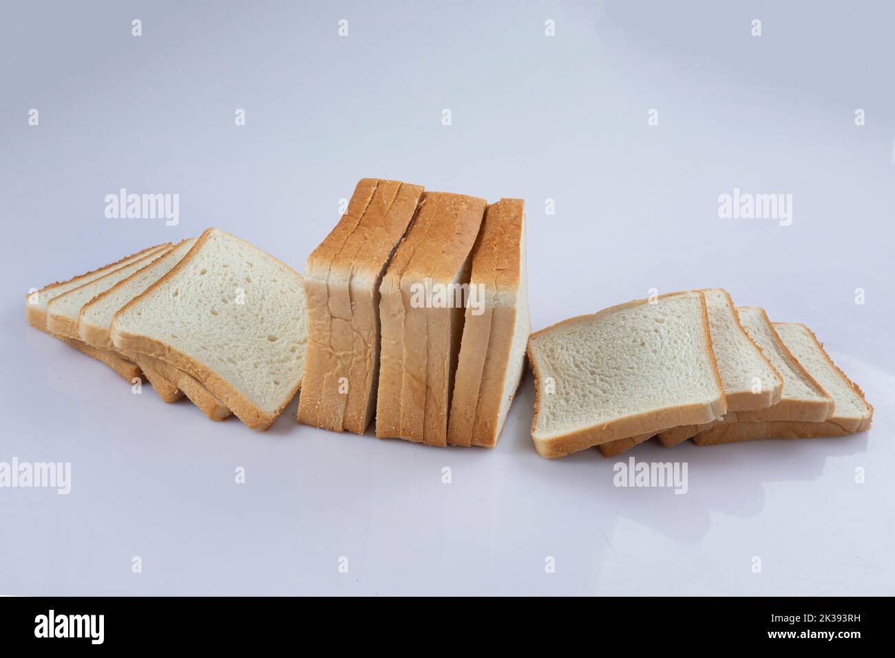 whole wheat bread slices on a white background Stock Photo - Alamy