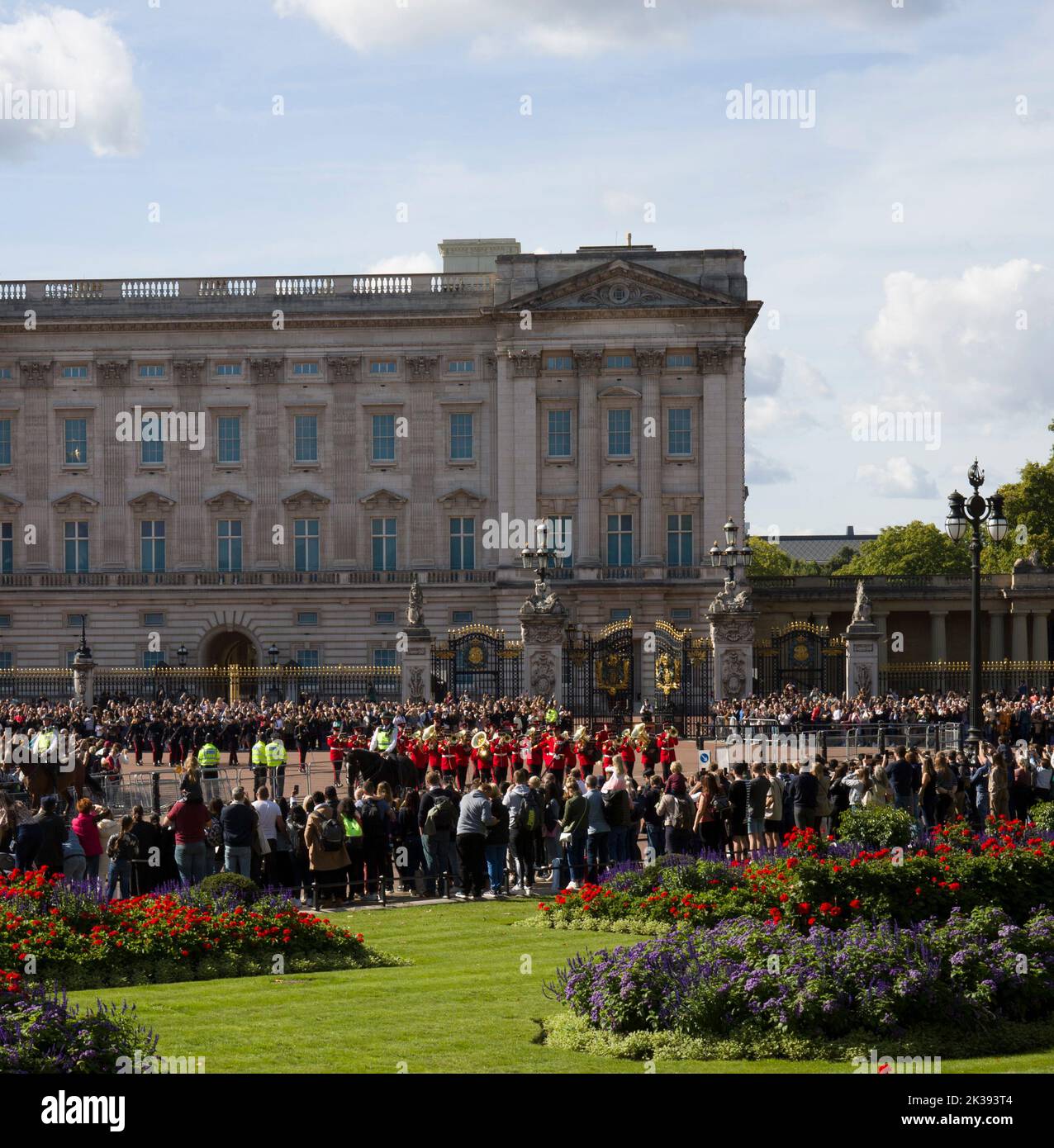 Crowds of Sightseers and Tourists Watching Marching Guards Band Queen Victoria Monument and Buckingham Palace London Stock Photo