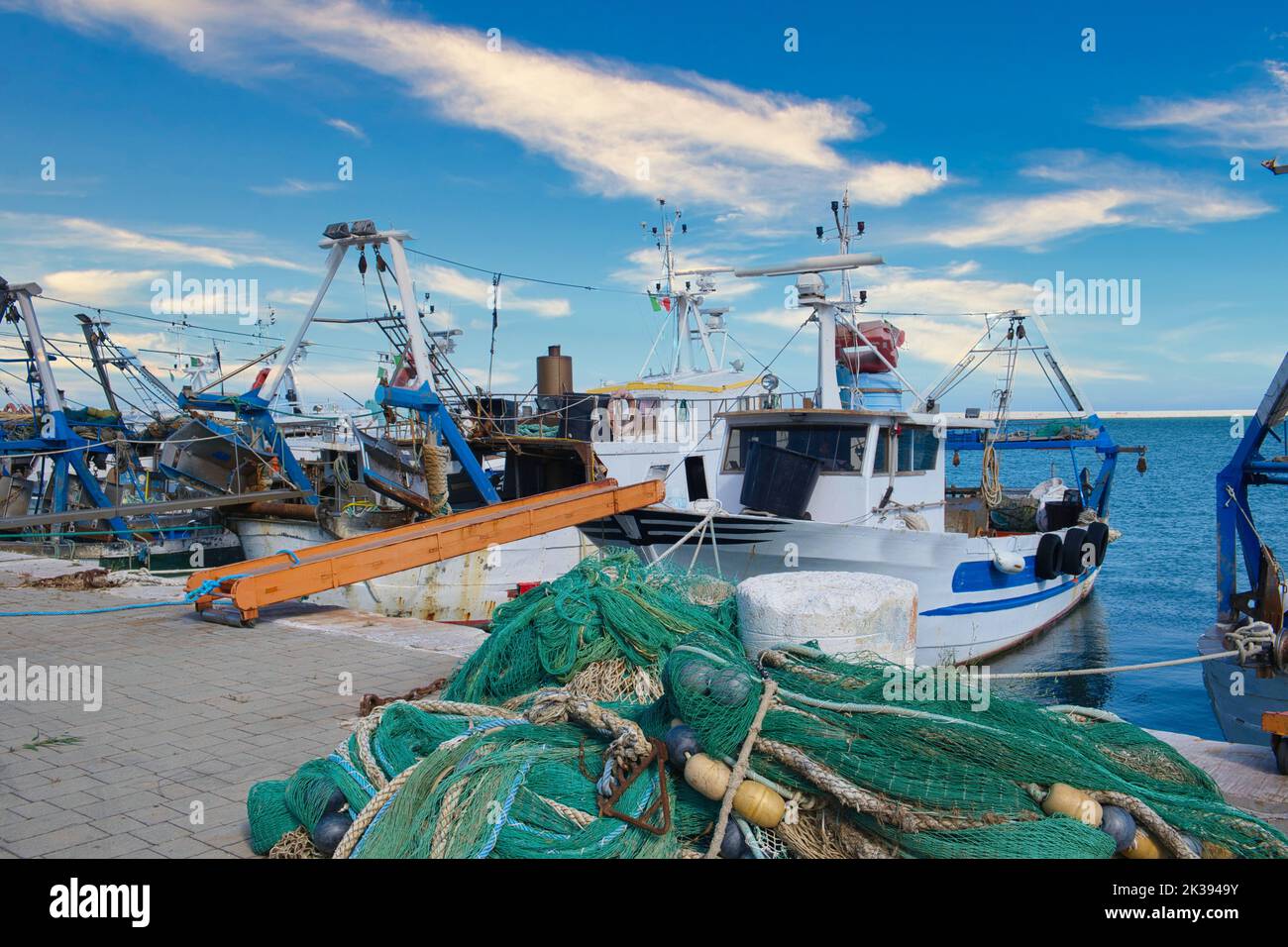 A lovely view of the harbor in Manfredonia, Italy with docked boats ...