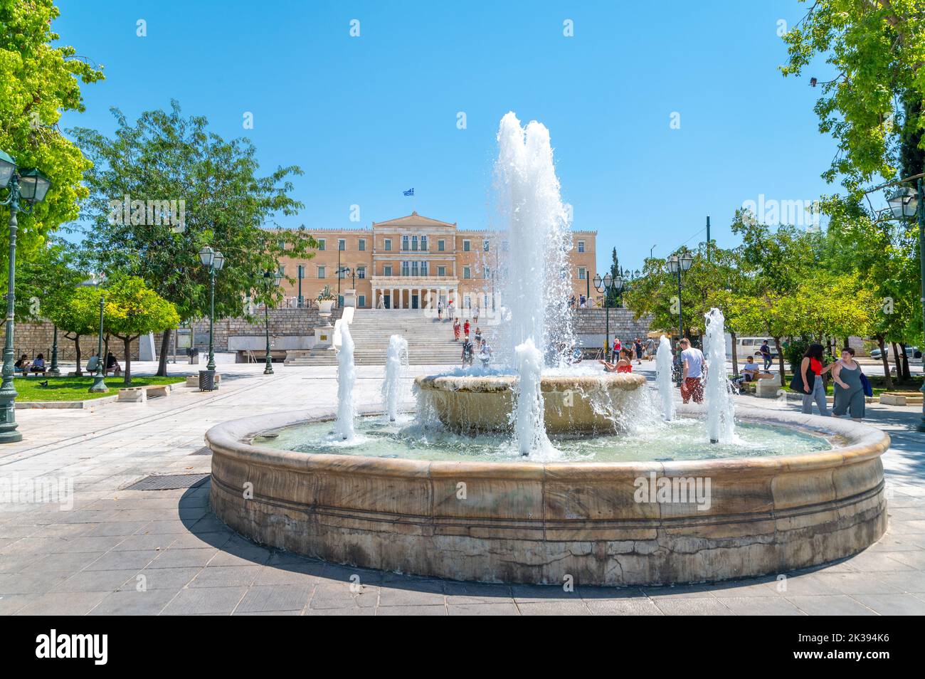Fountain in Syntagma square and the Greek parliament in Athens on a summer day Stock Photo