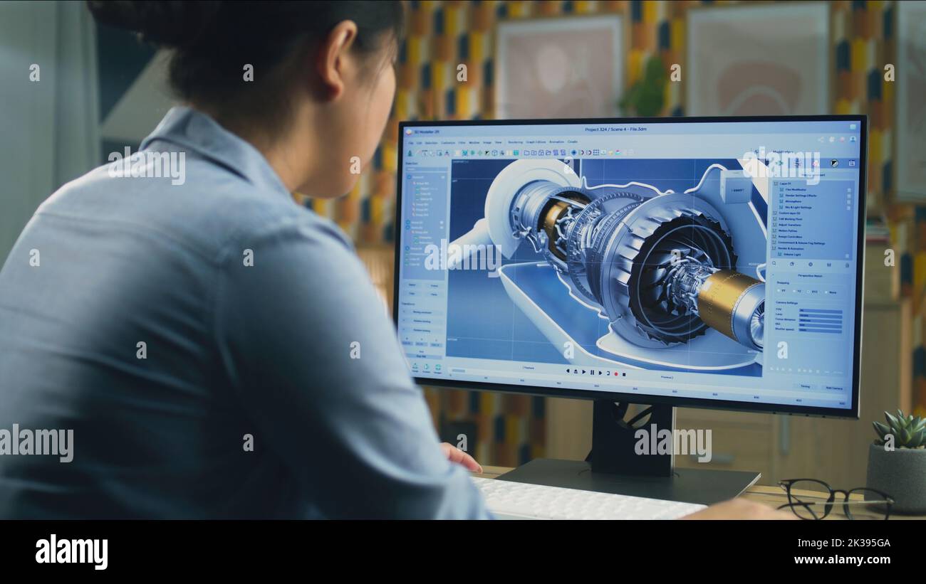 Asian female engineer drawing wind turbine 3D spare part in professional 3D modeling program on pc while working on project at home office Stock Photo