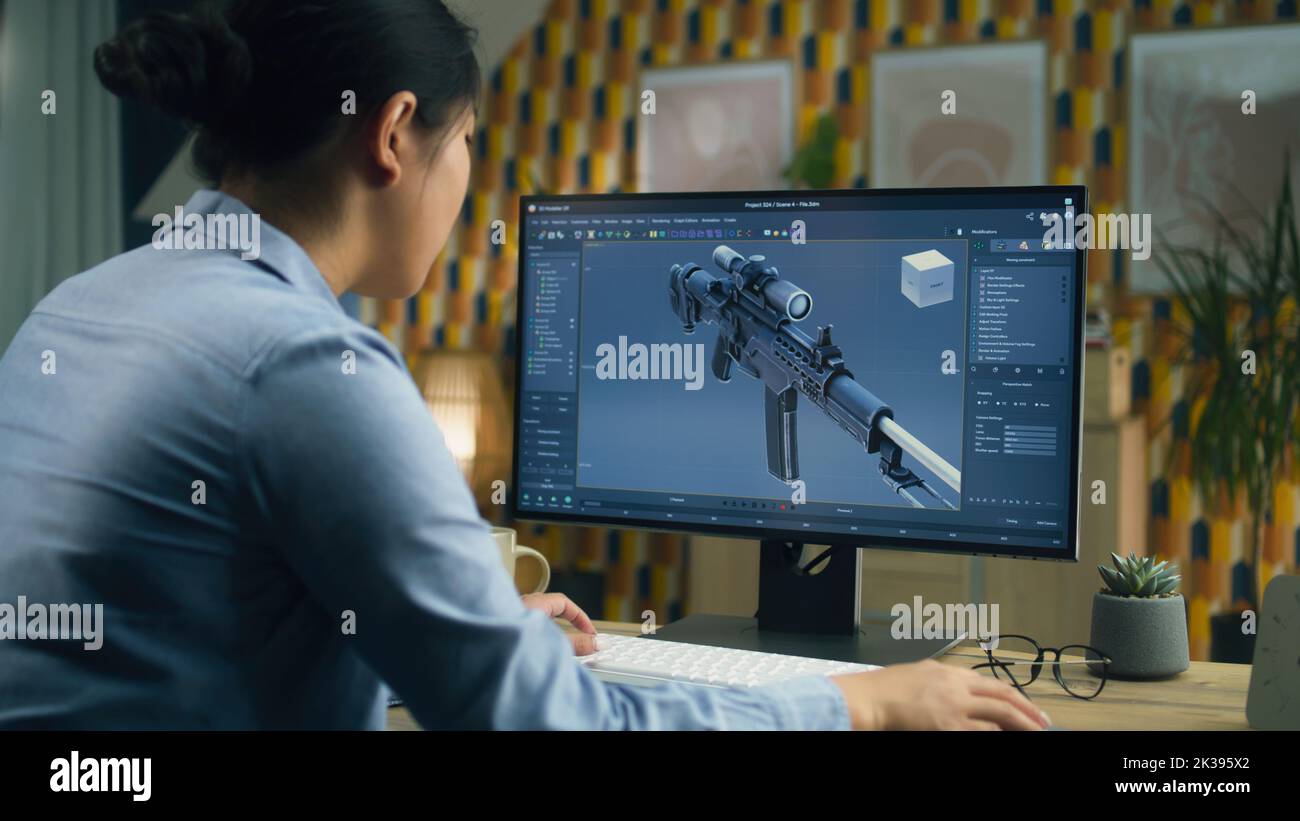 Female 3D designer creating 3D model of gun and making graphic using ...