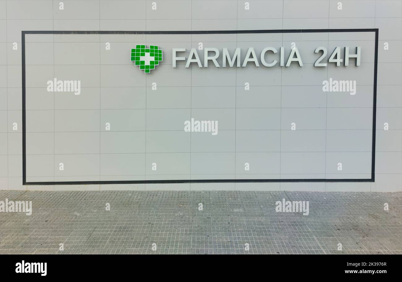 24-hour pharmacy wall. Spanish language lettering Stock Photo