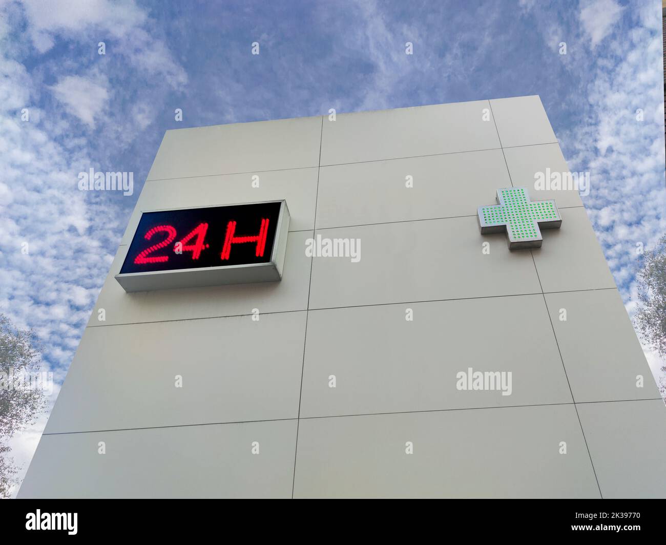 24-hour pharmacy wall. Building isolated over blue sky Stock Photo
