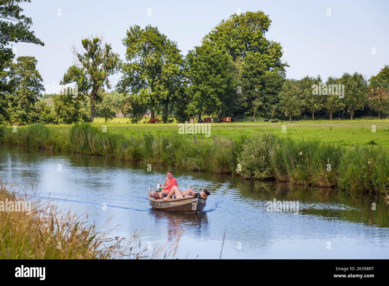 Nice girls sailing a rent boat on Netherlands river in the summertime Stock Photo