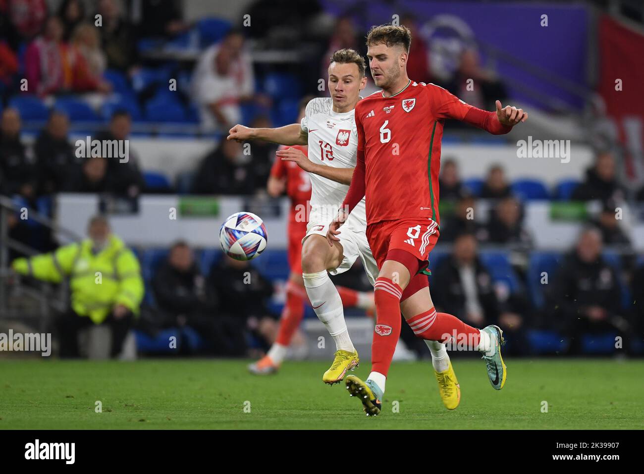 Joe Rodon of Wales Under pressure from Poland's Szymon ?urkowski during the UEFA Nations League Group A4 match between Wales vs Poland at Cardiff City Stadium, Cardiff, United Kingdom, 25th September 2022  (Photo by Mike Jones/News Images) Stock Photo