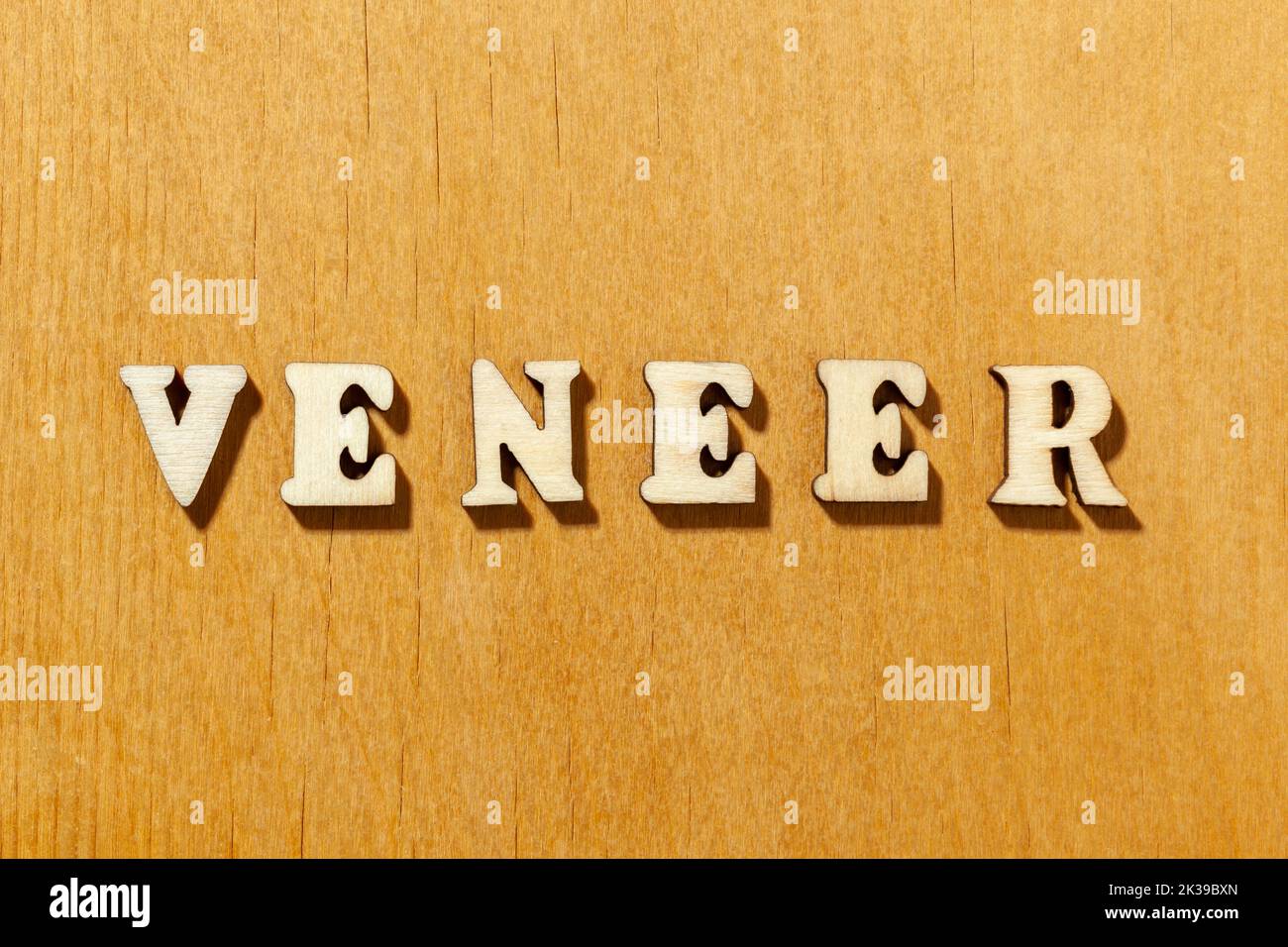 Word 'Veneer' by wooden letters close up Stock Photo