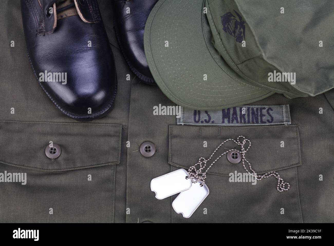 April 30 2019. U.S. MARINES cap, dog tags and boots on olive green