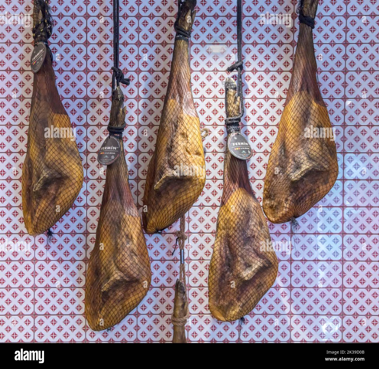 Iberian ham legs hanging Stock Photo - Alamy