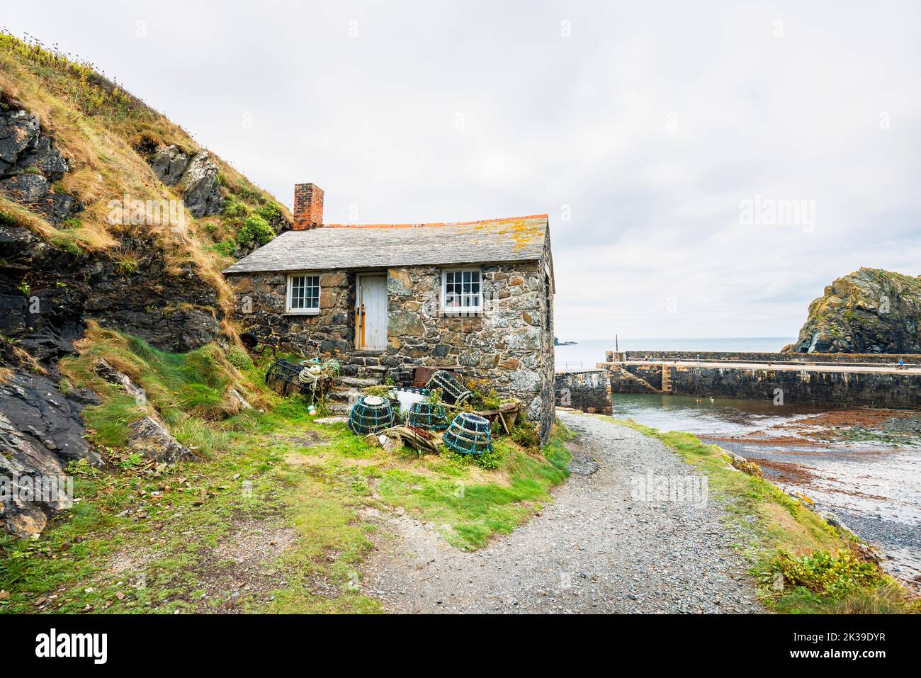 Harbour Cottage, the Net Loft Fishermen’s Cottage, an early 19th century listed building in Mullion Cove on the west of the Lizard Peninsula, Cornwall Stock Photo