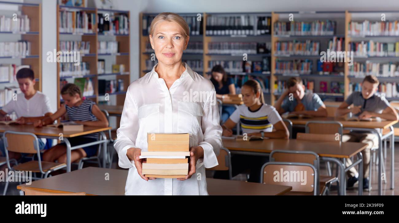 Portrait of mature woman teacher standing in classroom Stock Photo - Alamy