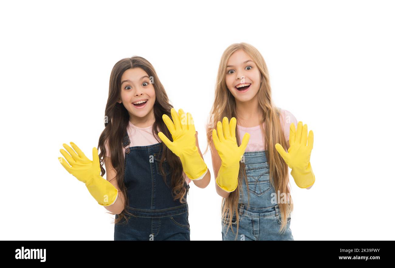 Household cares. Happy small girls wearing household rubber gloves. Little children using gloves for household activities. Household help Stock Photo