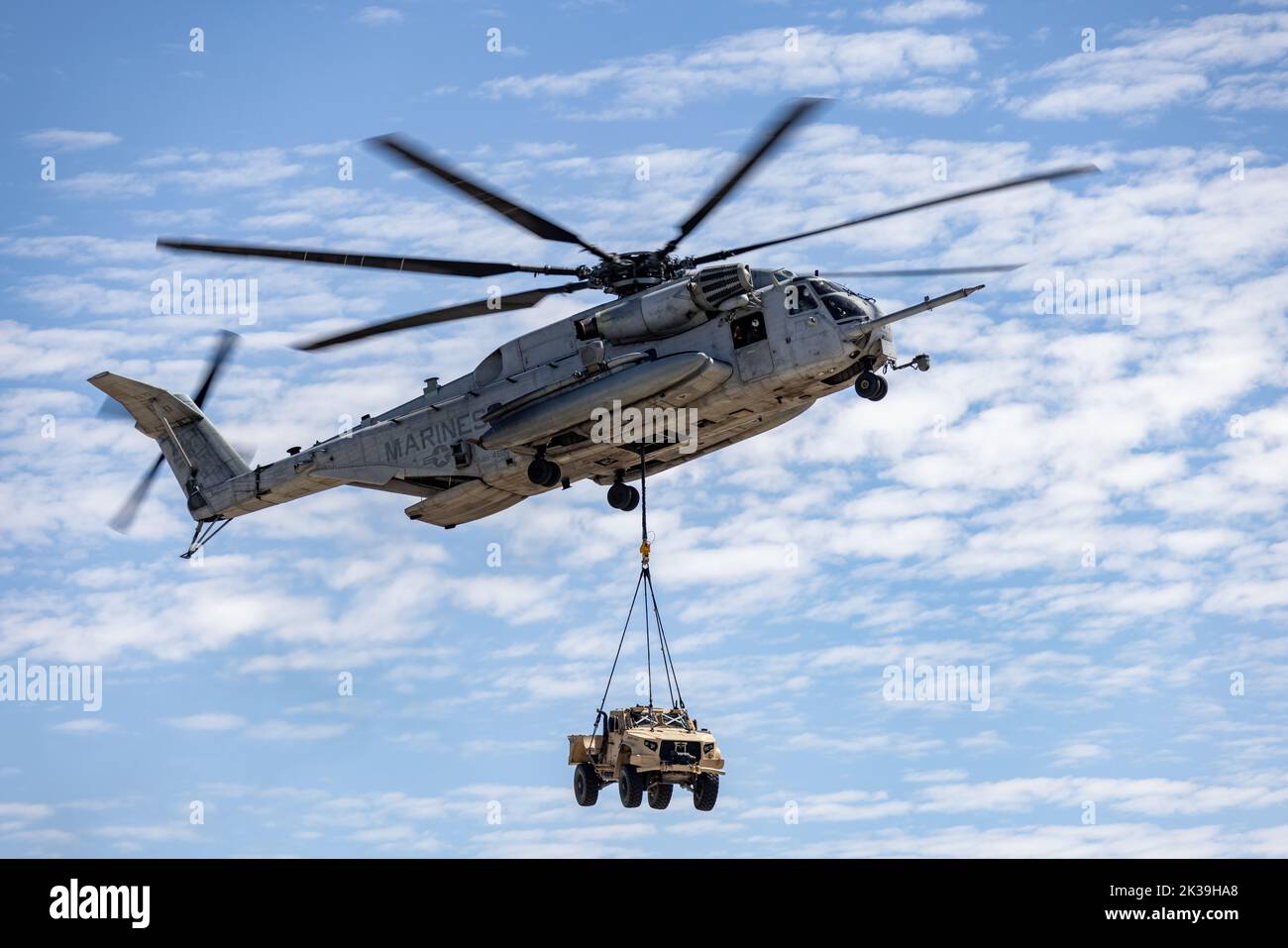 A CH-53E Super Stalion with Marine Heavy Helicopter Squadron 465, carries a Joint Light Tactical Vehicle during the Marine Air-Ground Task Force demonstration of the 2022 Marine Corps Air Station Miramar Air Show at MCAS Miramar, San Diego, California, Sept. 24, 2022. The MAGTF Demo displays the coordinated use of close-air support, artillery and infantry forces, and provides a visual representation of how the Marine Corps operates. The theme for the 2022 MCAS Miramar Air Show, “Marines Fight, Evolve and Win,” reflects the Marine Corps’ ongoing modernization efforts to prepare for future confl Stock Photo