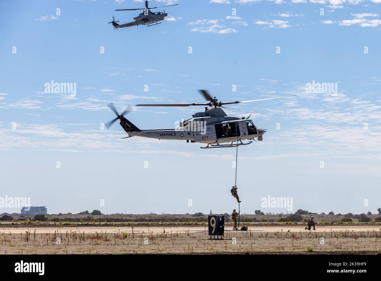 U.S. Marines with 1st Reconnaisance Battalion, 1st Marine Division, fast rope out of a UH-1Y Huey during the Marine Air-Ground Task Force demonstration of the 2022 Marine Corps Air Station Miramar Air Show at MCAS Miramar, San Diego, California, Sept. 24, 2022. The MAGTF Demo displays the coordinated use of close-air support, artillery and infantry forces, and provides a visual representation of how the Marine Corps operates. The theme for the 2022 MCAS Miramar Air Show, “Marines Fight, Evolve and Win,” reflects the Marine Corps’ ongoing modernization efforts to prepare for future conflicts. ( Stock Photo