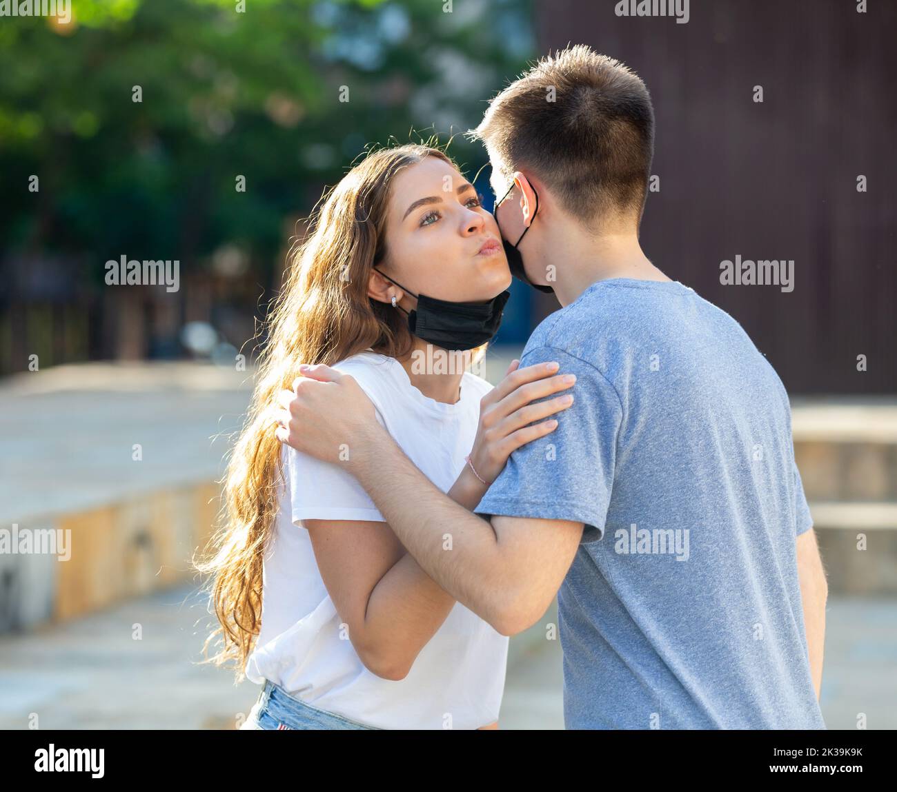 Girl is kissing a guy Stock Photo - Alamy