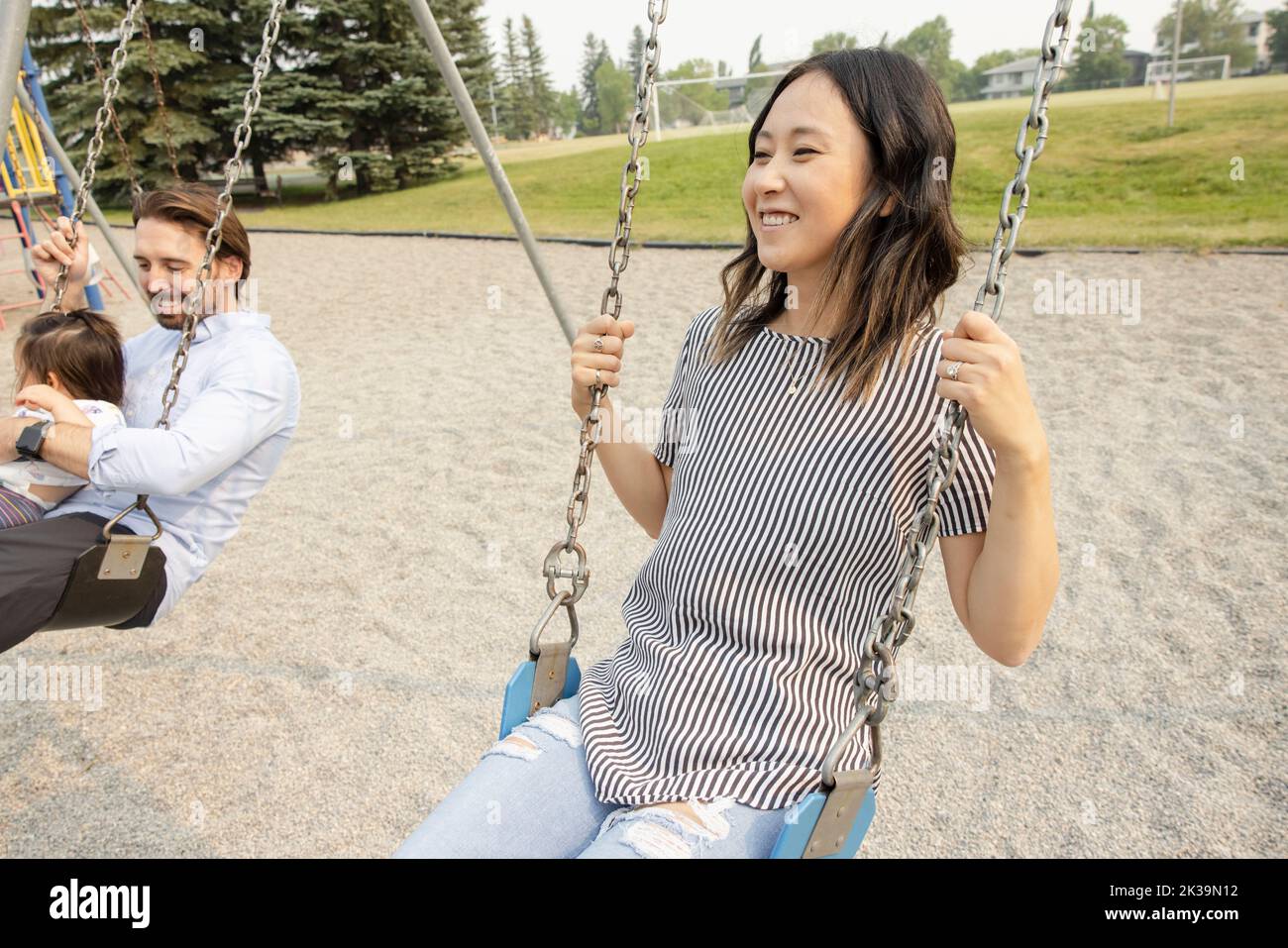 Black girl sitting on swing hi-res stock photography and images - Alamy