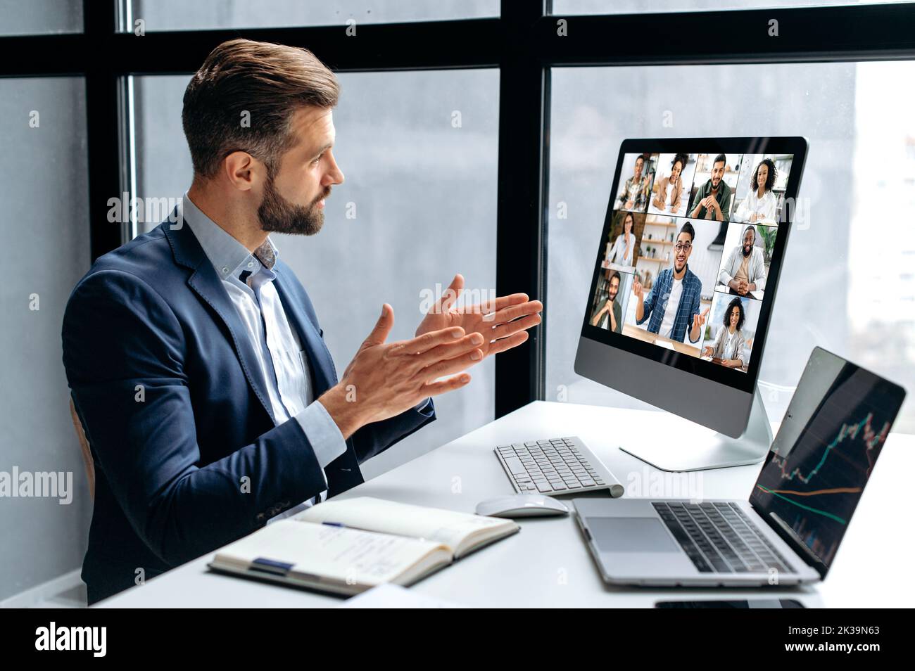 Side view at a successful man, company boss, stock investor, having financial brainstorm with group of multiracial people by video conference, discuss investments in the stock market, risks Stock Photo