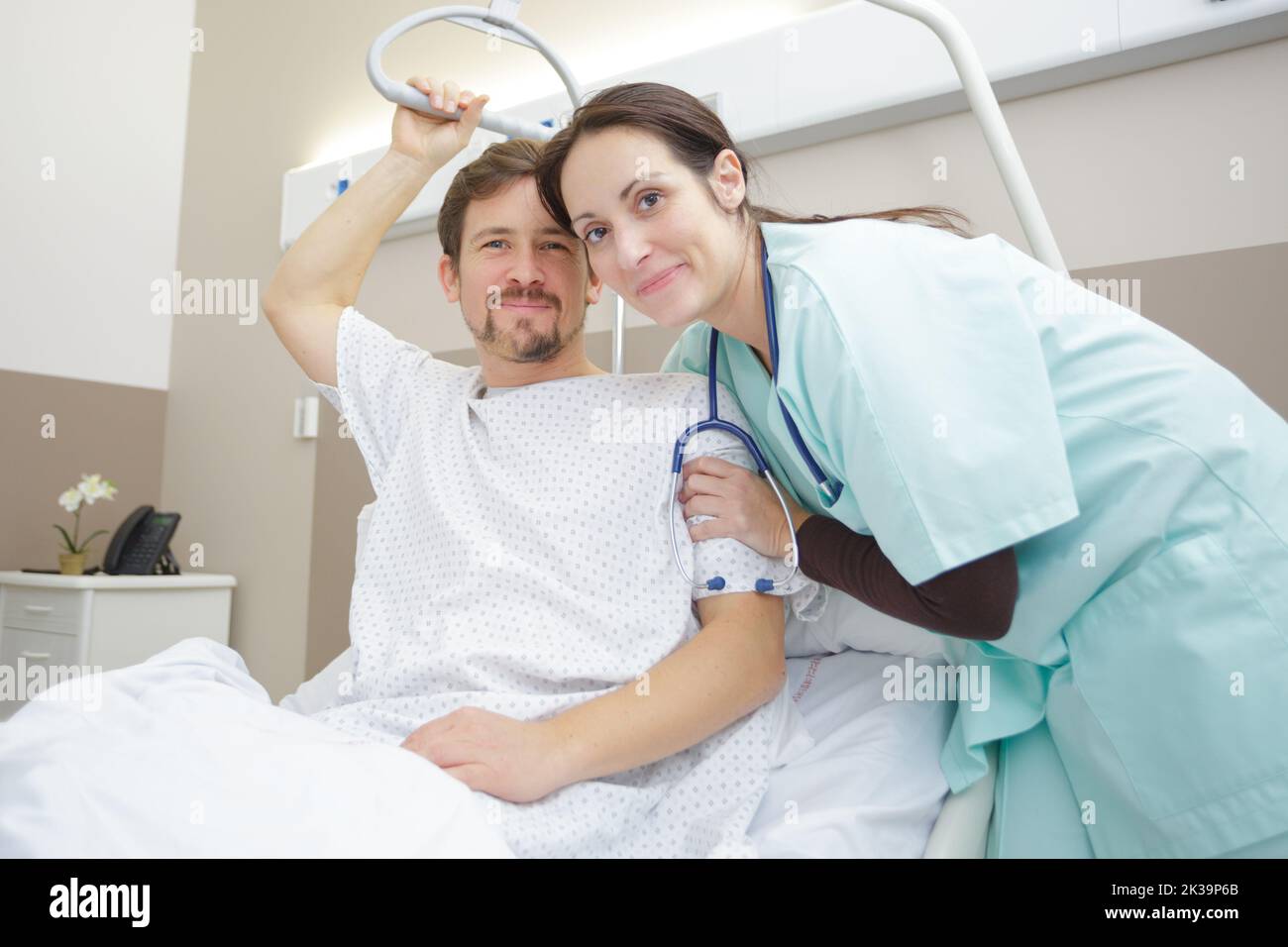 helping patient in a hospital bed Stock Photo Alamy