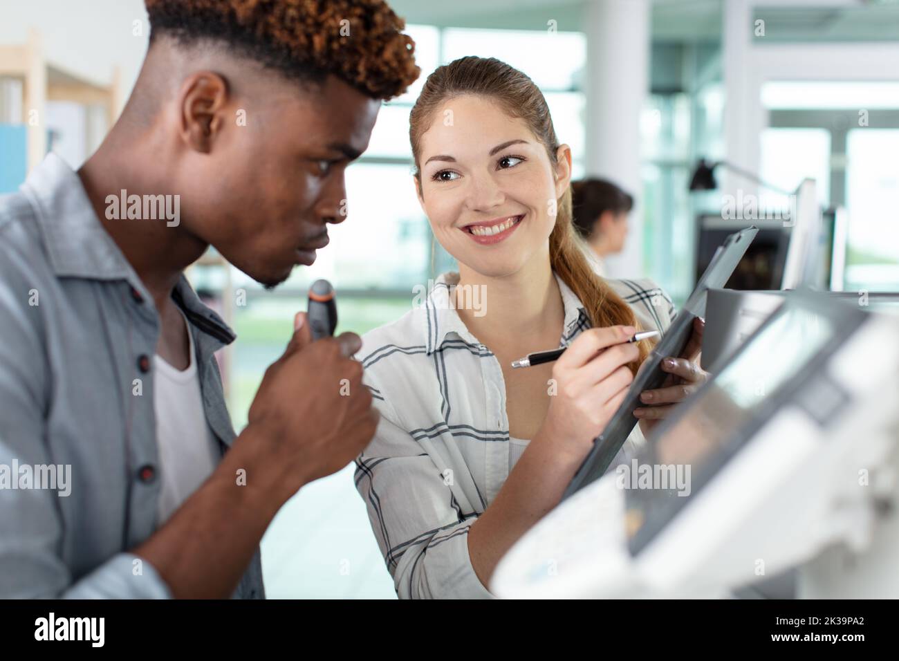 two designers working with printer in design studio Stock Photo
