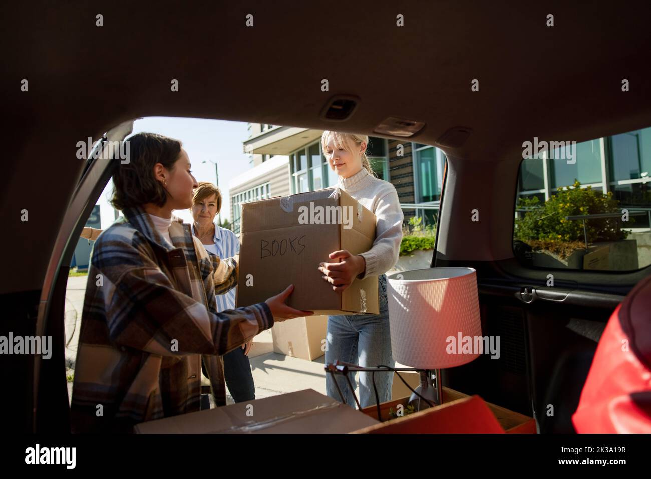 College students unpacking belongings from car Stock Photo Alamy