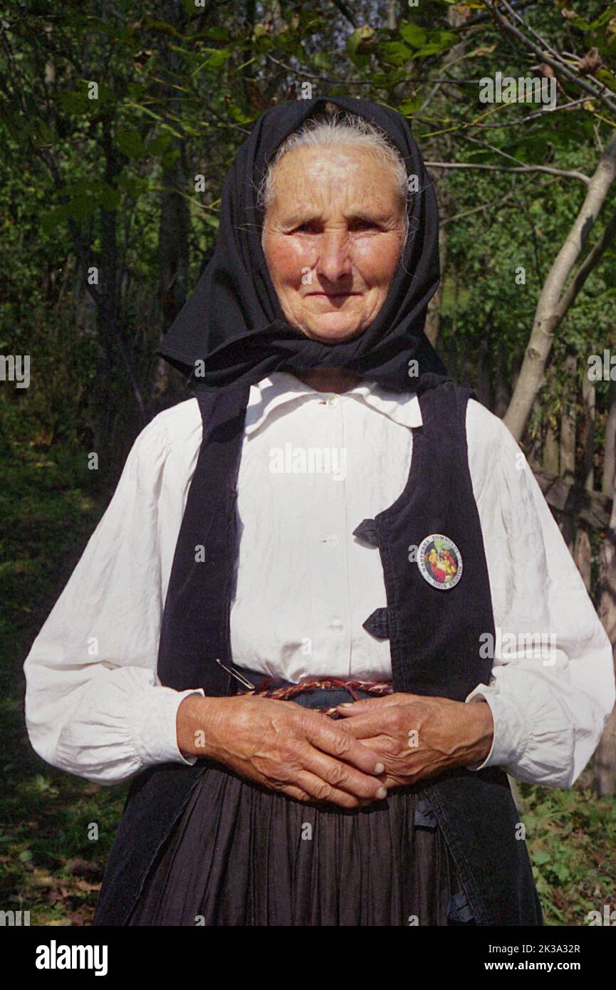 Poșaga, Alba County, Romania, approx. 1999. Elderly woman in traditional black and white clothing. Stock Photo