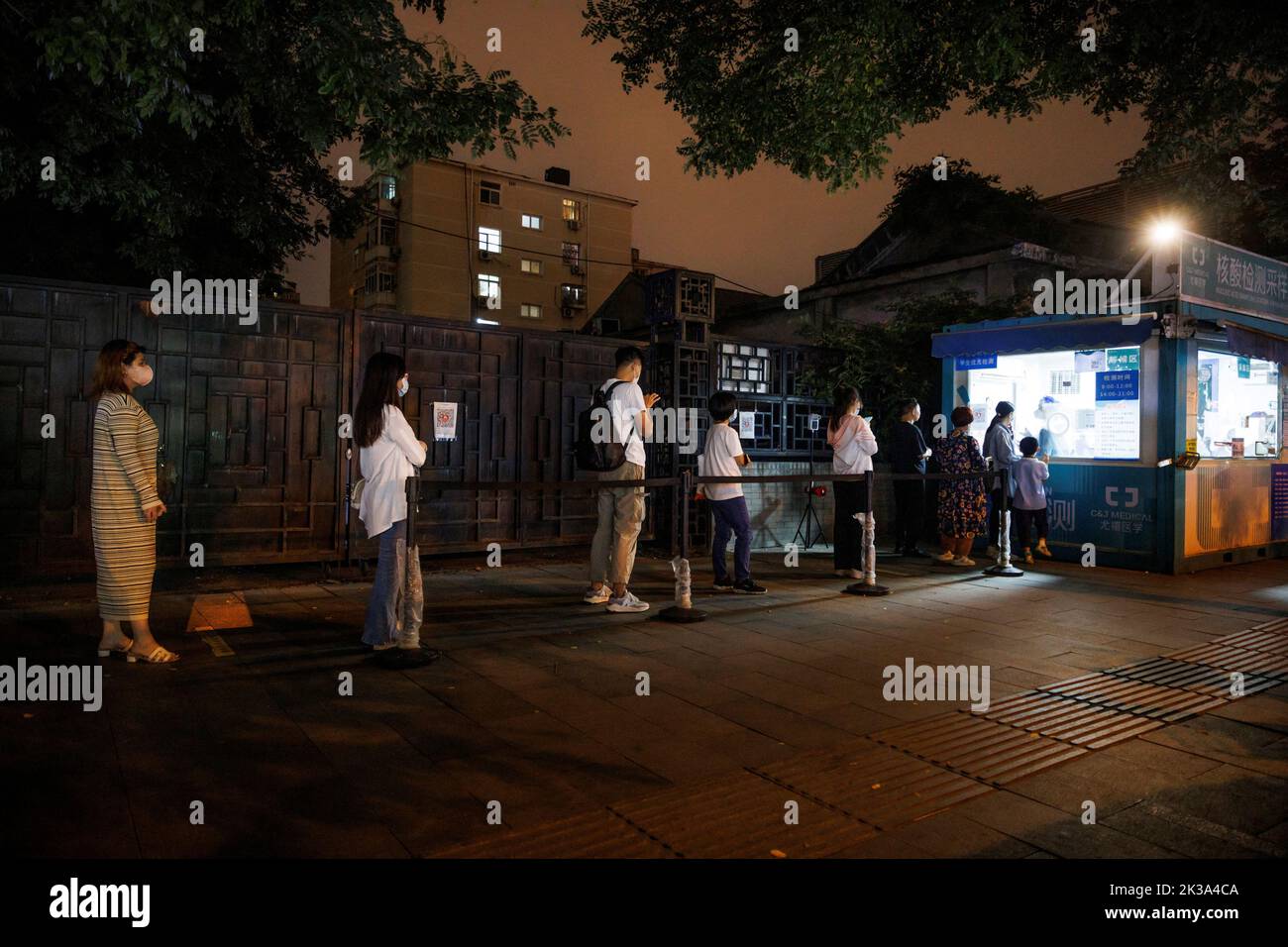 People line up to get a swab at a nucleic acid testing station, set up city-wide to trace possible coronavirus disease (COVID-19) outbreaks in Beijing, China, September 19, 2022. REUTERS/Thomas Peter Stock Photo