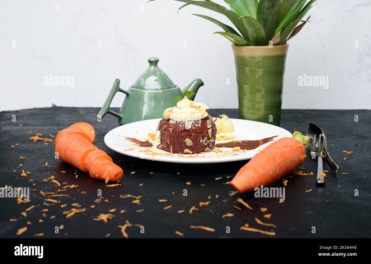 Carrot chocolate cake on plate and black background Stock Photo