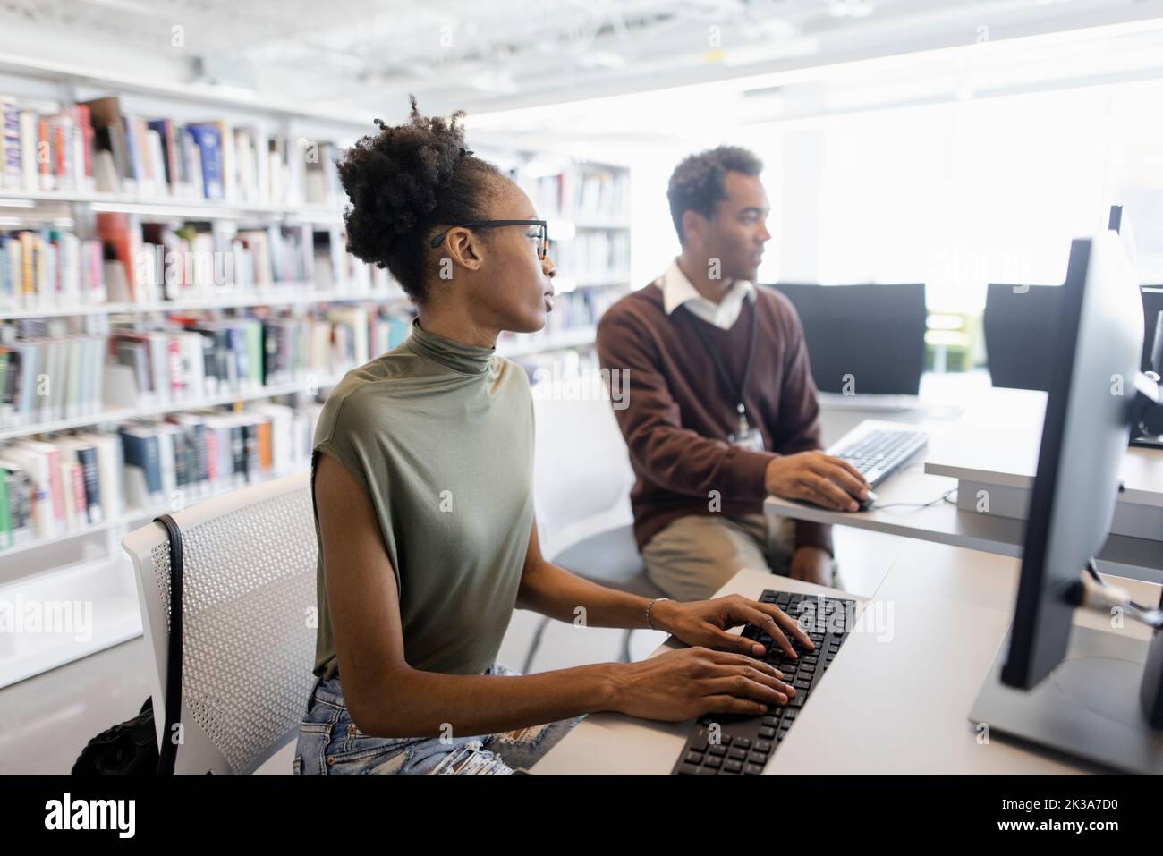 College students using computers in library Stock Photo Alamy