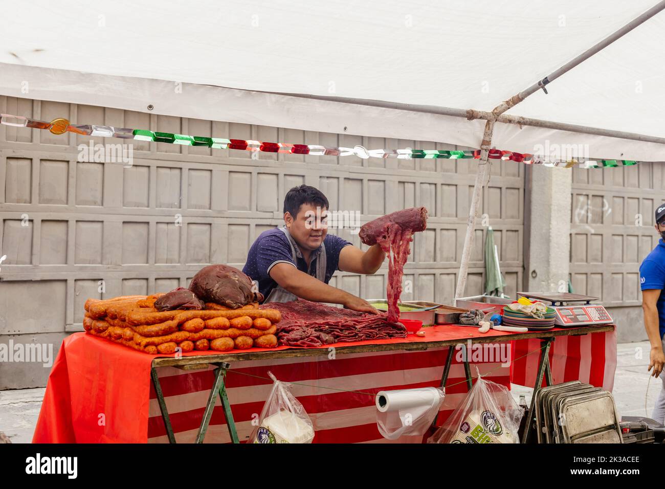 mexican market butcher prepares his product for sale Stock Photo