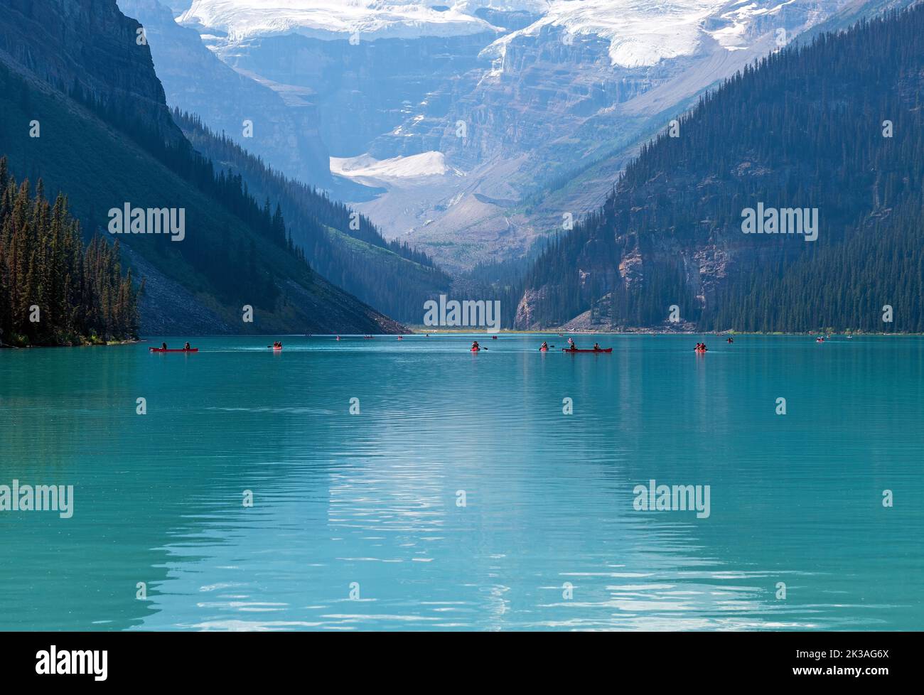 Lake Louise with people kayaking and Victoria Glacier reflection, Banff national park, Alberta, Canada. Stock Photo