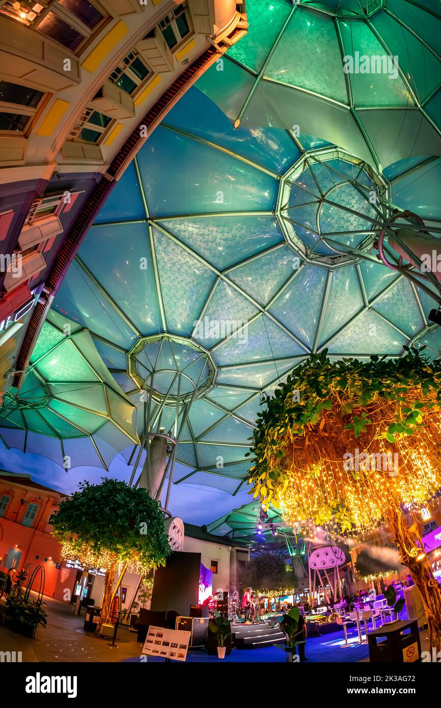 Street view of lighted Clarke Quay in historic riverside quay, famous