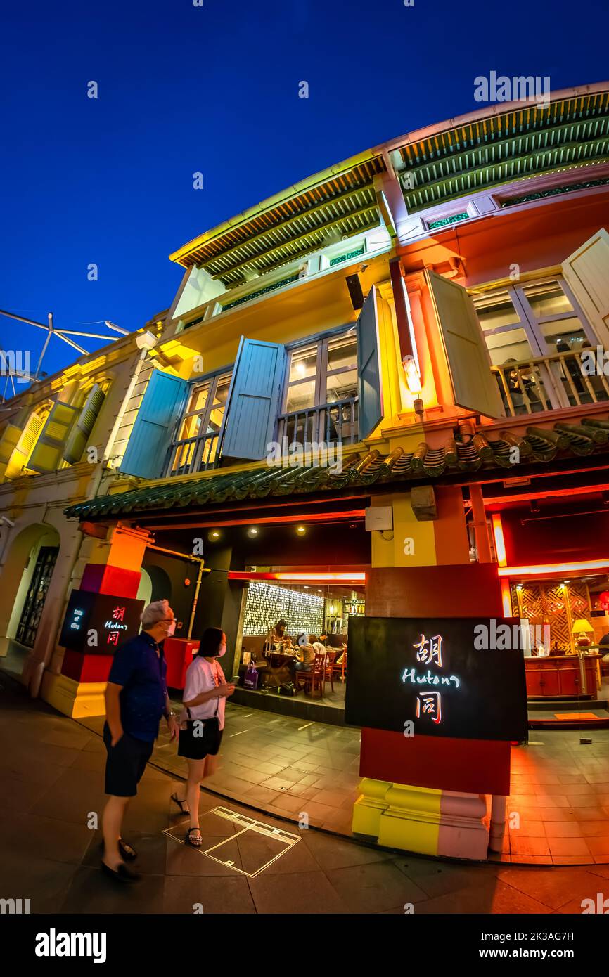 Street view of lighted Clarke Quay in historic riverside quay, famous