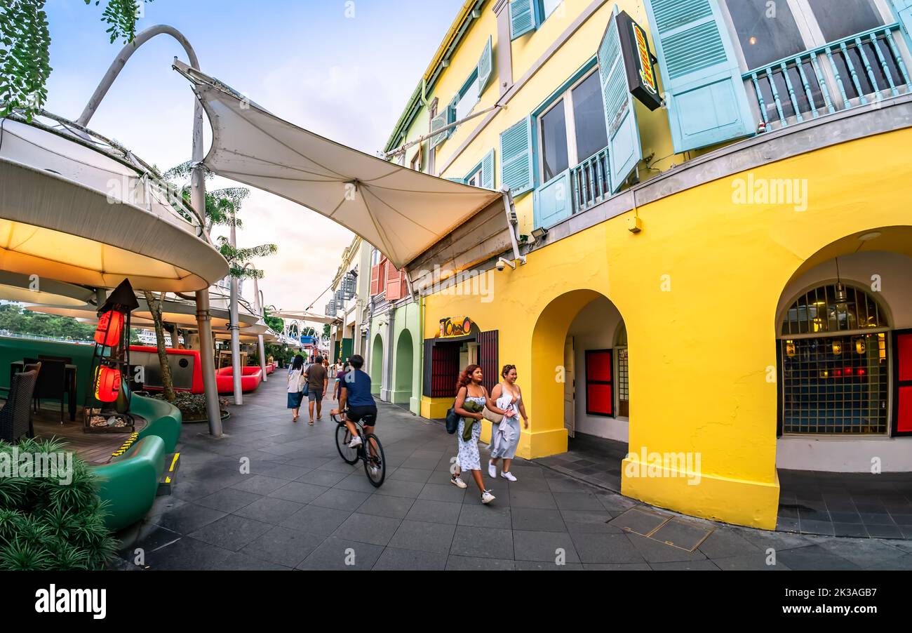 Street view of lighted Clarke Quay in historic riverside quay, famous