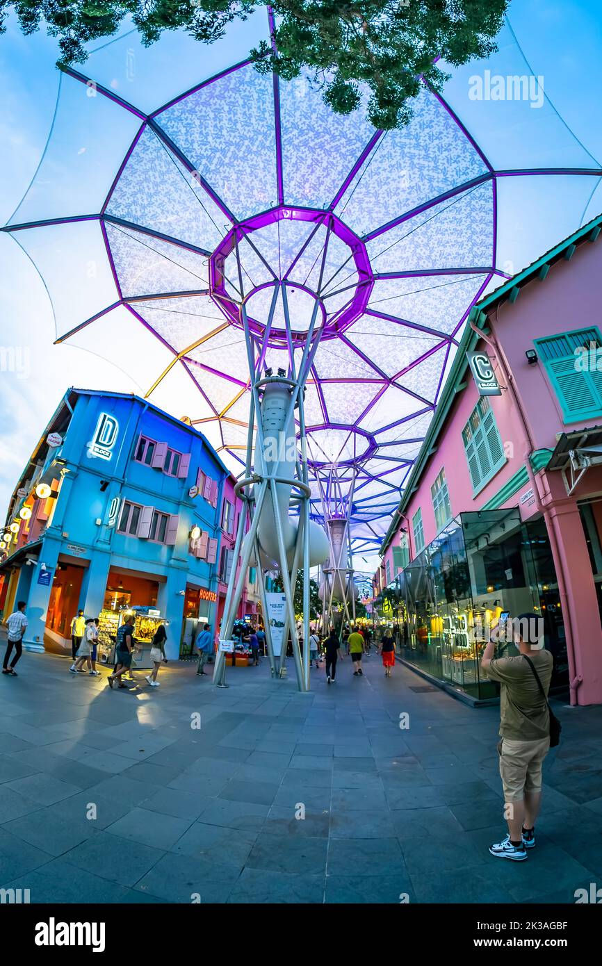 Street view of lighted Clarke Quay in historic riverside quay, famous